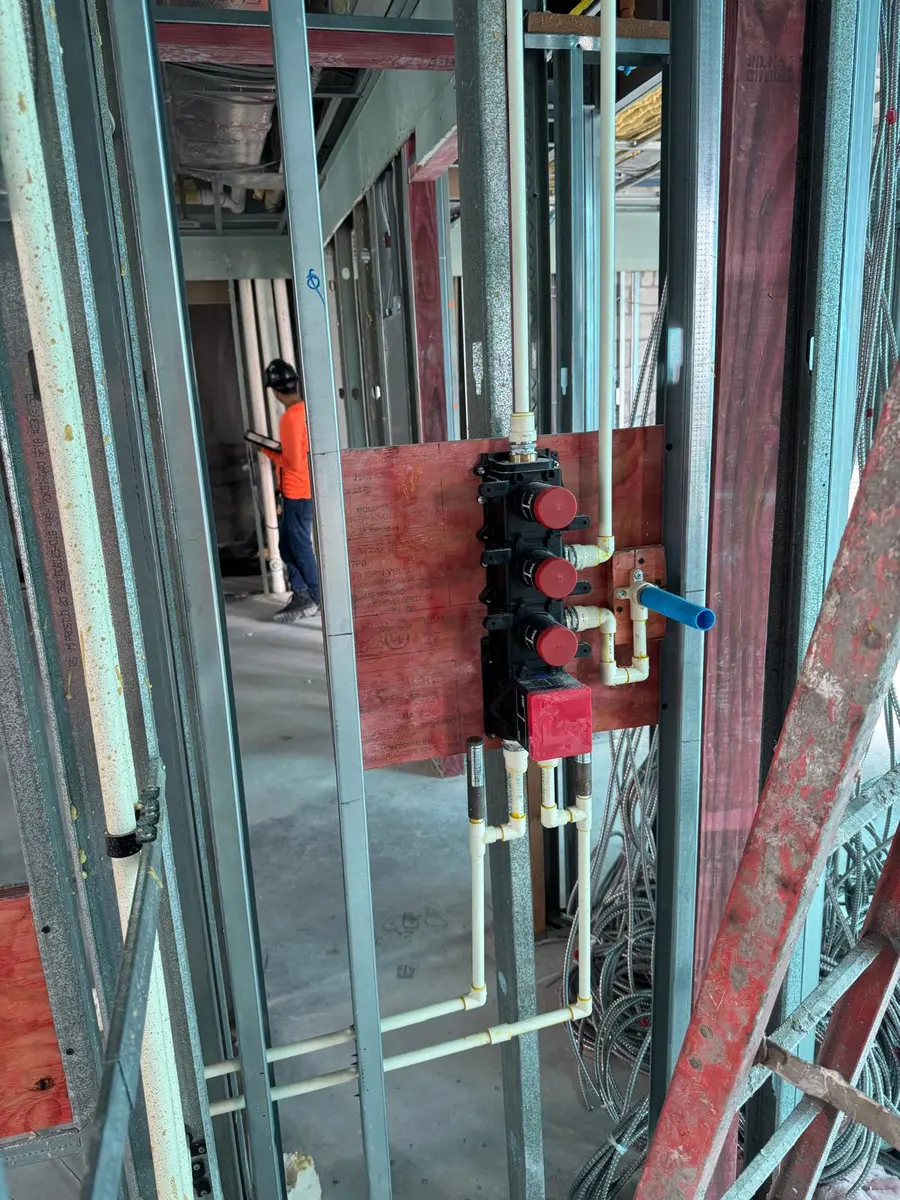 Water manifold roughed into a framed commercial wall